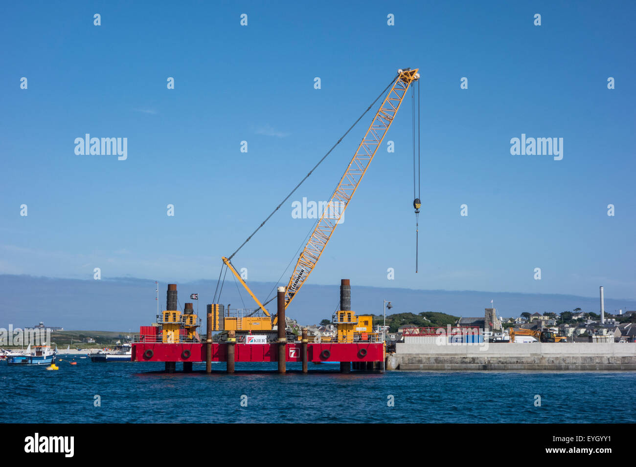 Construction work, involving a crane, to lengthen the harbour wall on St Mary's, Isles of Scilly, Cornwall Stock Photo