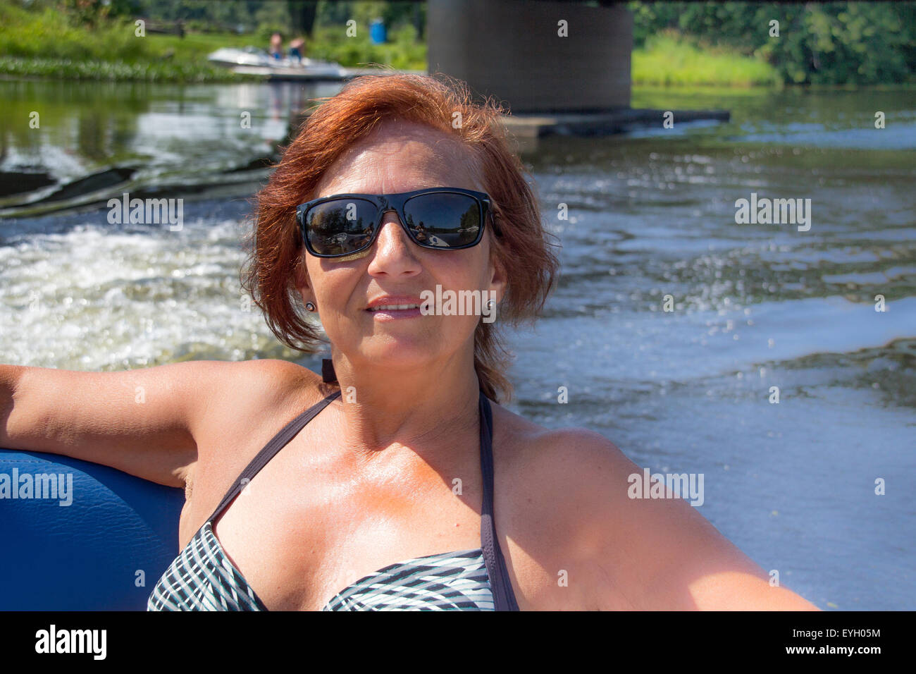 mature women vacation on recreational motor boat on summer day Stock Photo