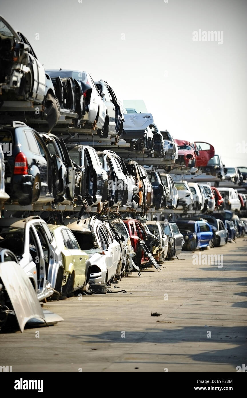 Wrecked vehicles are seen in a car junkyard Stock Photo