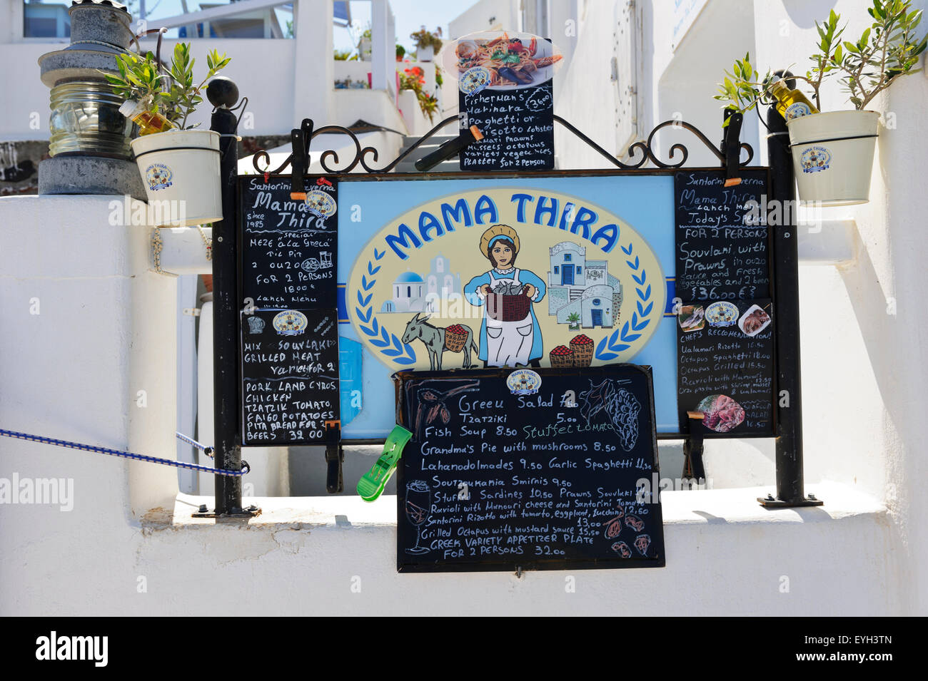 A menu and a sign of Mama Thira restaurant in Santorini, Greece Stock