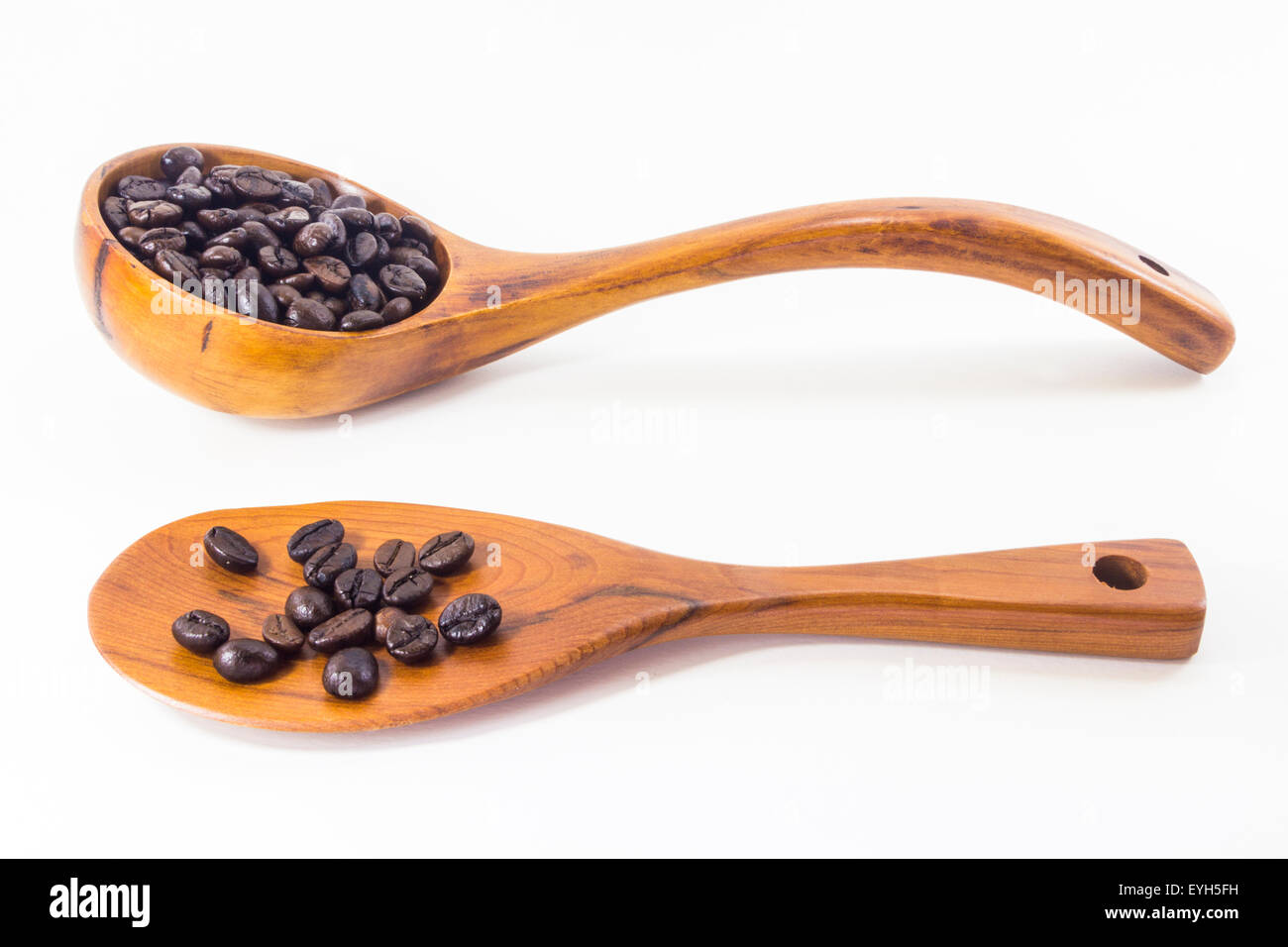 Coffee beans in a wooden spoon white background Stock Photo - Alamy