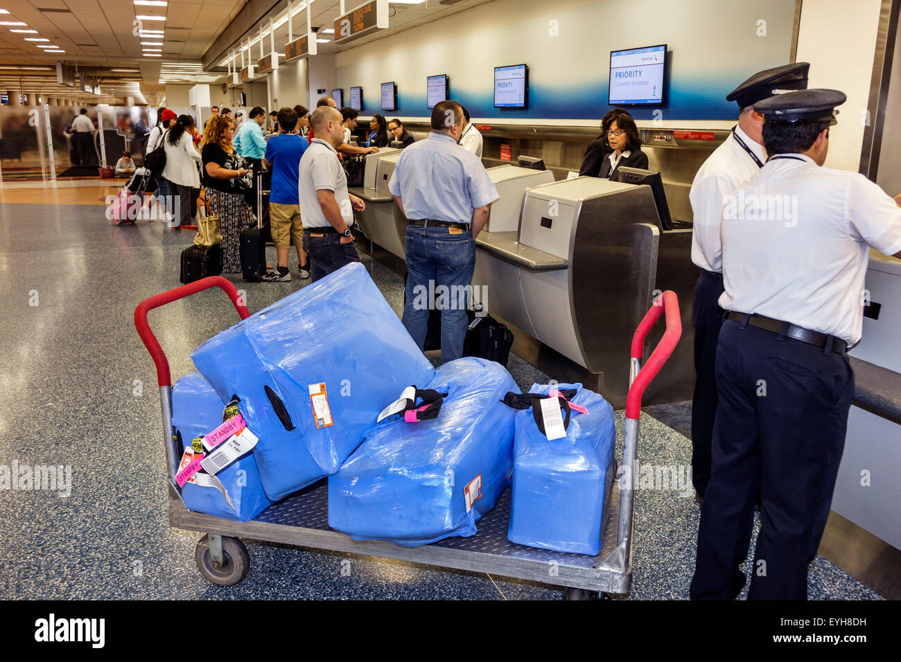 Miami Florida,International Airport,MIA,terminal,gate,interior inside,ticket counter,cart,luggage,skycap,FL150626006 Stock Photo