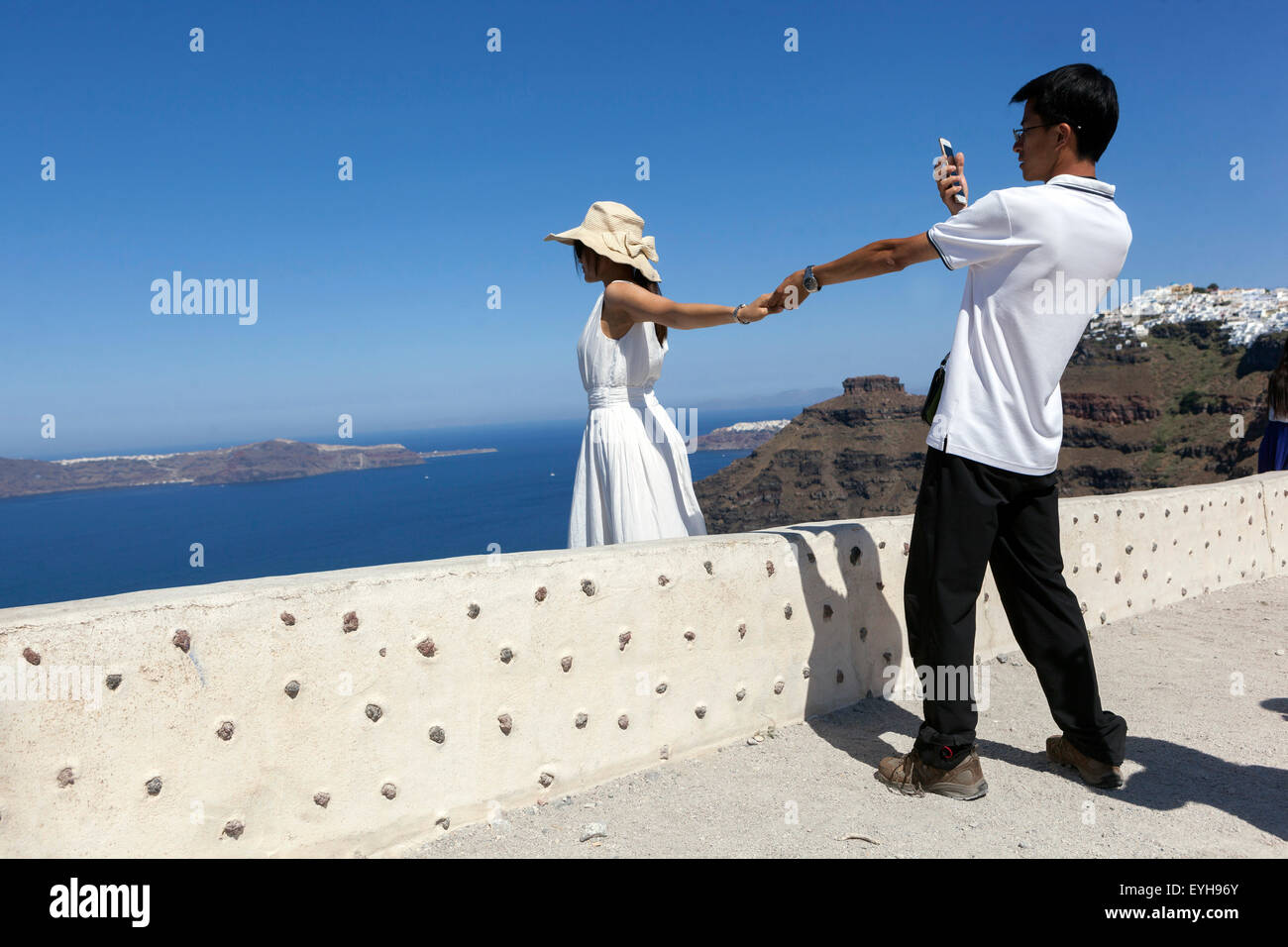 Couple taking photos. Firostefani, Santorini couple, Greek Islands, Greece, EU, Europe Stock Photo