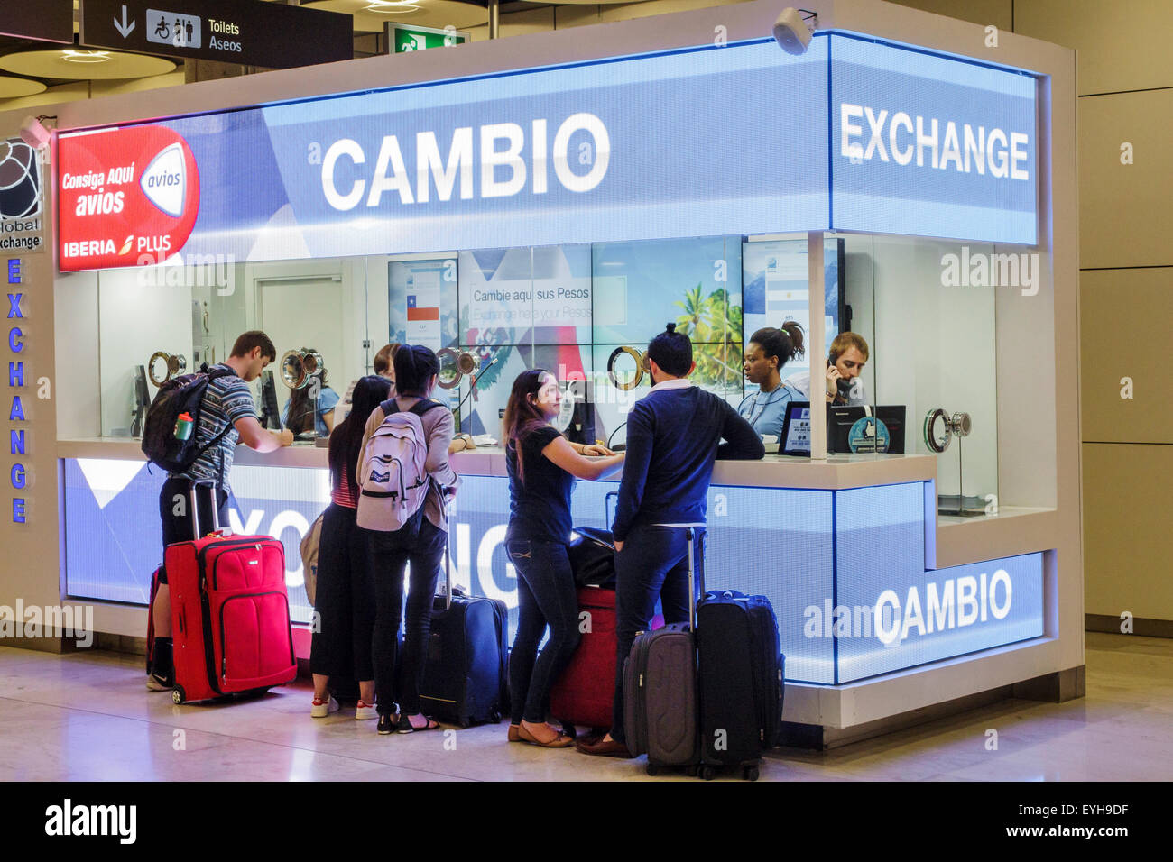 Spain,MAD,Adolfo Suarez Madrid-Barajas Airport,international,interior inside,terminal,gate,currency exchange,Hispanic man men male,woman female women, Stock Photo