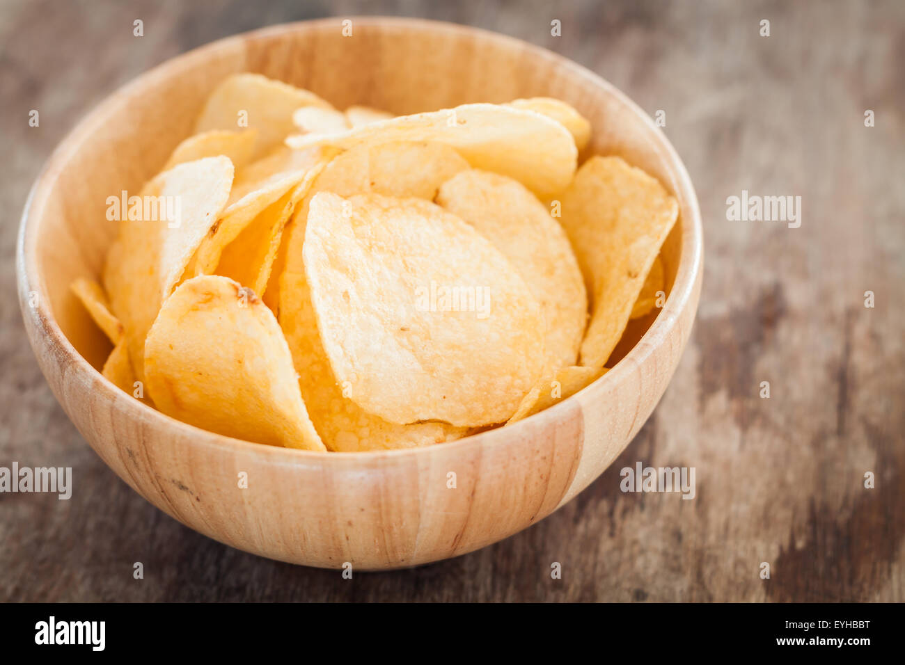 Crispy potato chips on wooden background, stock photo Stock Photo - Alamy