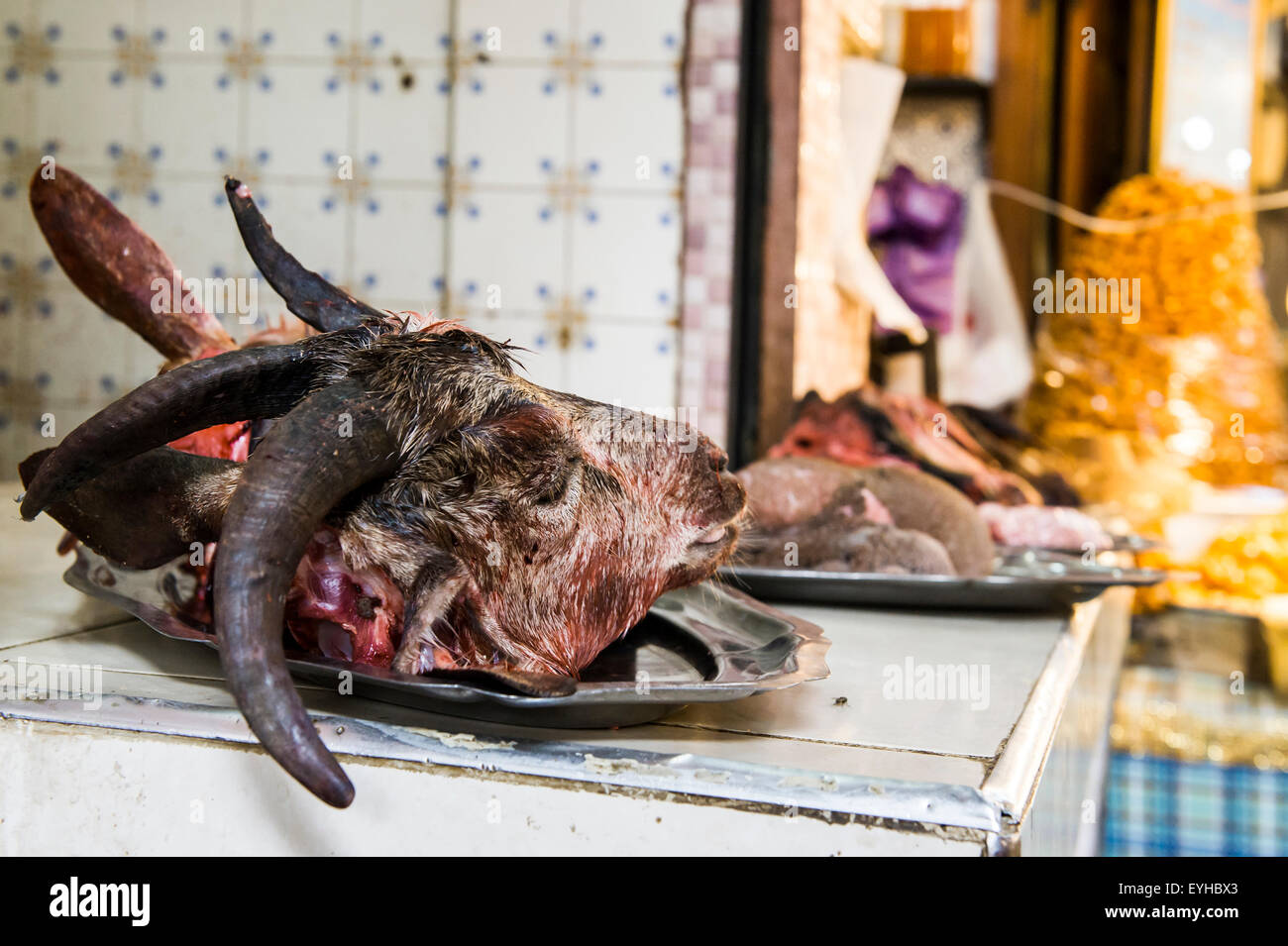 Butcher's with goat head on display, Souk, Fes, Morocco Stock Photo