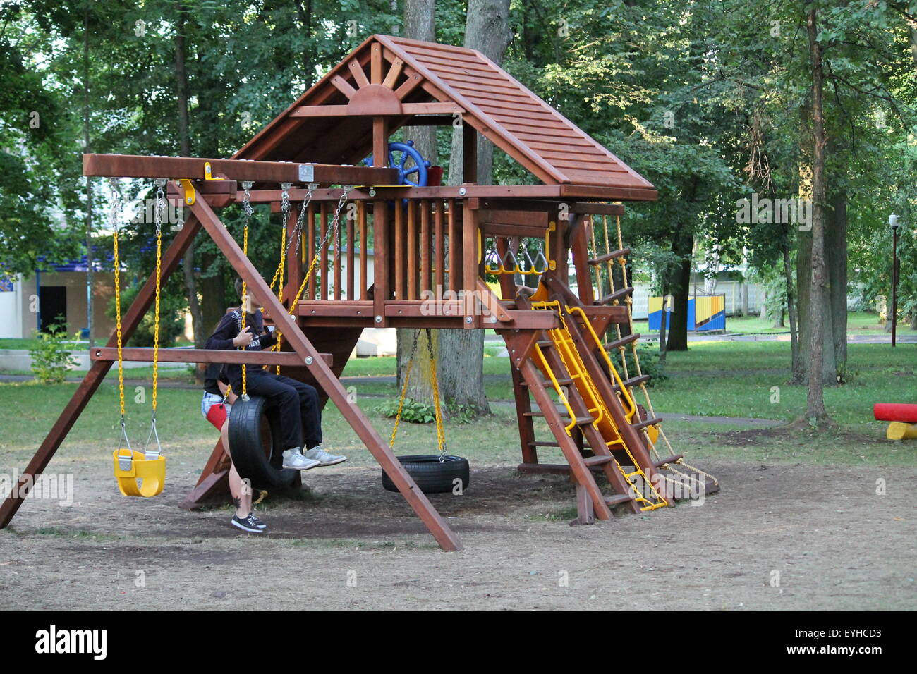 beautiful cozy and convenient playground with slide, swing and ladders in summer city park Stock Photo
