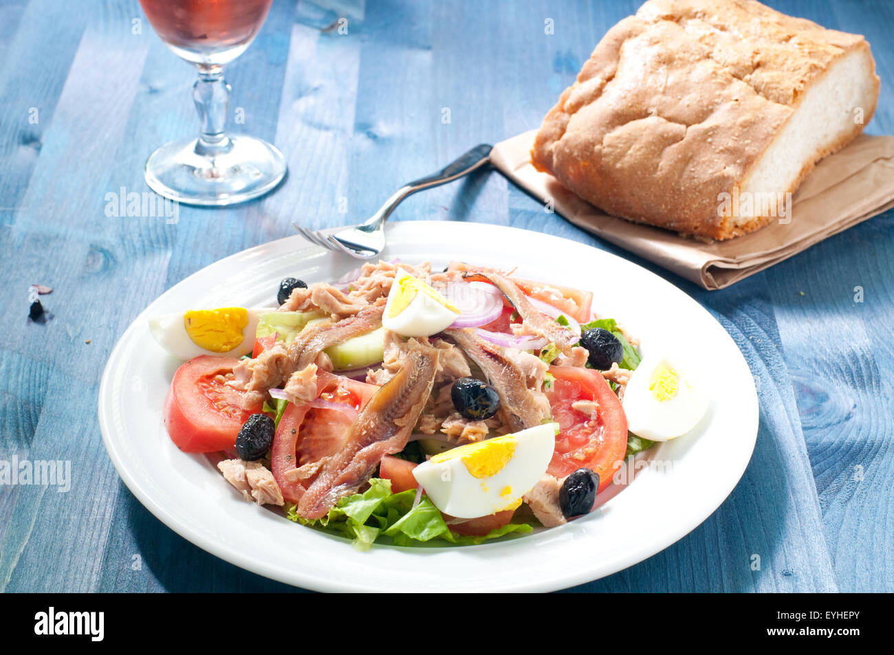 Nicoise salad with egg , anchovies , onions , lettuce and tuna Stock