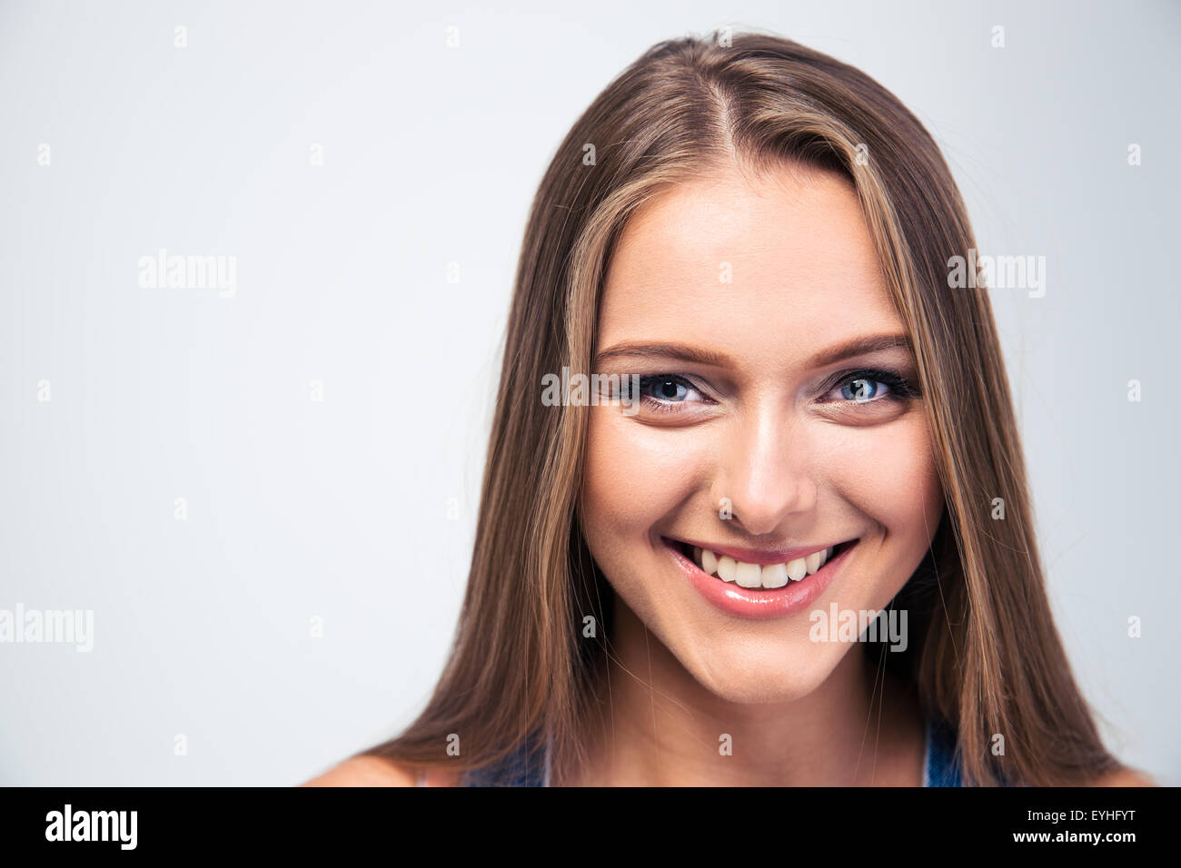 Closeup portrait of a smiling young woman isolated on a white ...