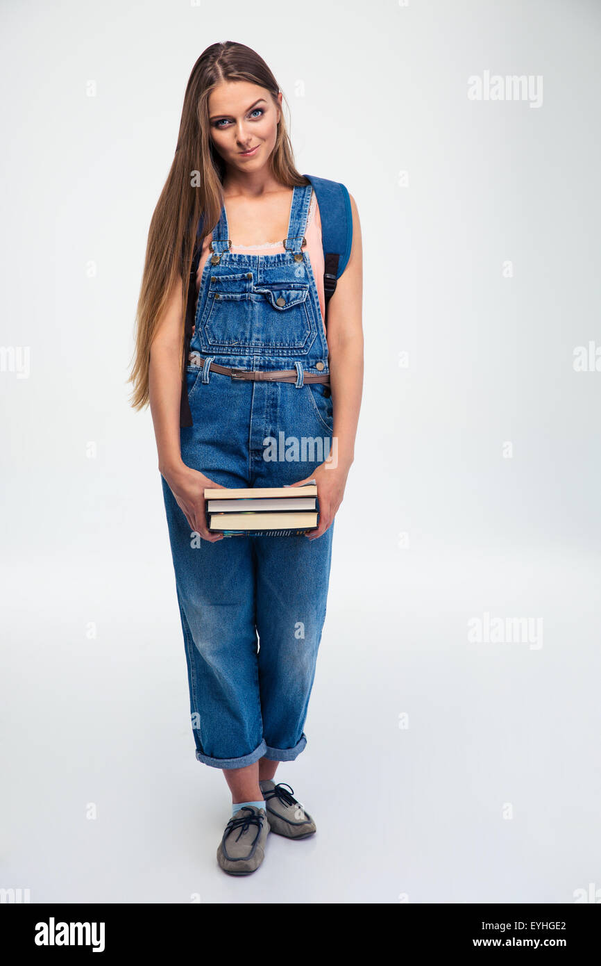 Full length portrait of a cute female student holding books isolated on ...