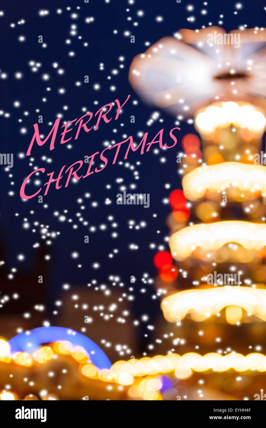 Snowy Merry Christmas Lights Silhouette - Defocused soft lights background of nostalgic christmas holiday fairground Stock Photo