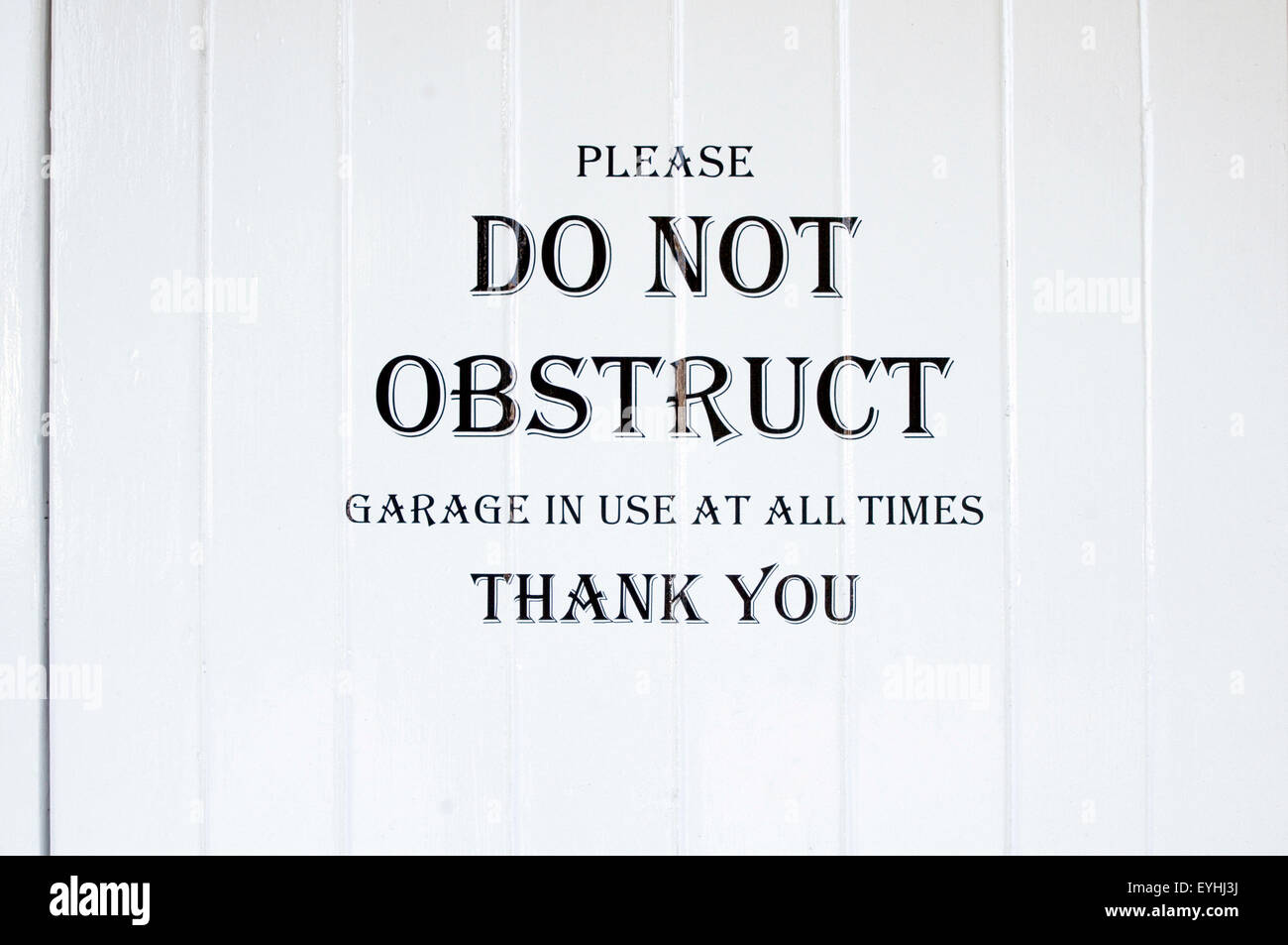 polite notice please don not obstruct garage in use at all times thank you sign signs block in blocked Stock Photo