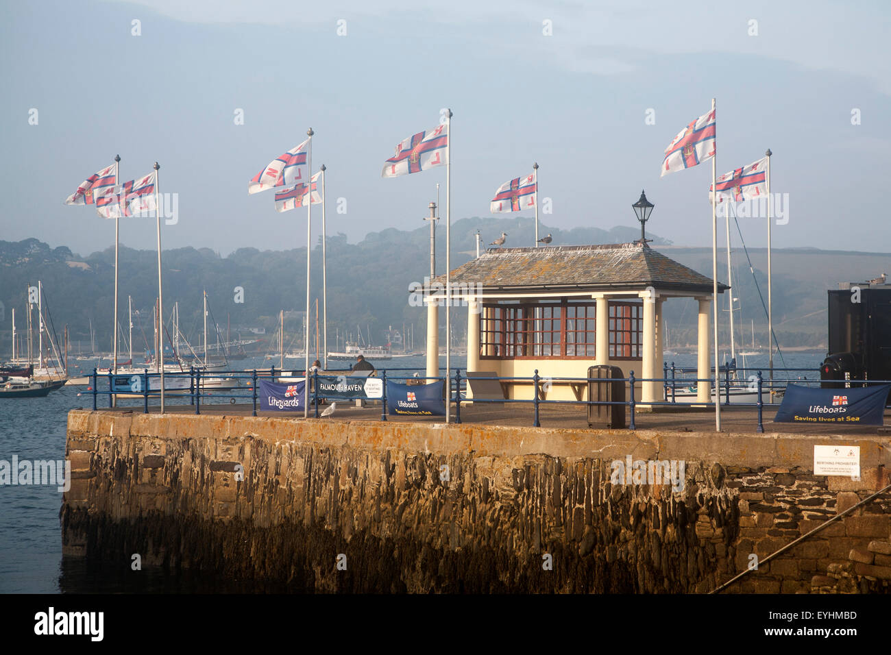 RNLI flags flying in the breeze on Prince of Wales pier, Falmouth, Cornwall, England, UK Stock Photo