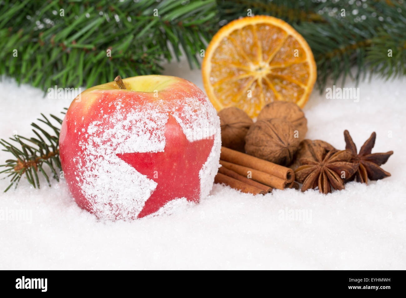 Winter apple fruit on Christmas decoration with snow and spices Stock Photo