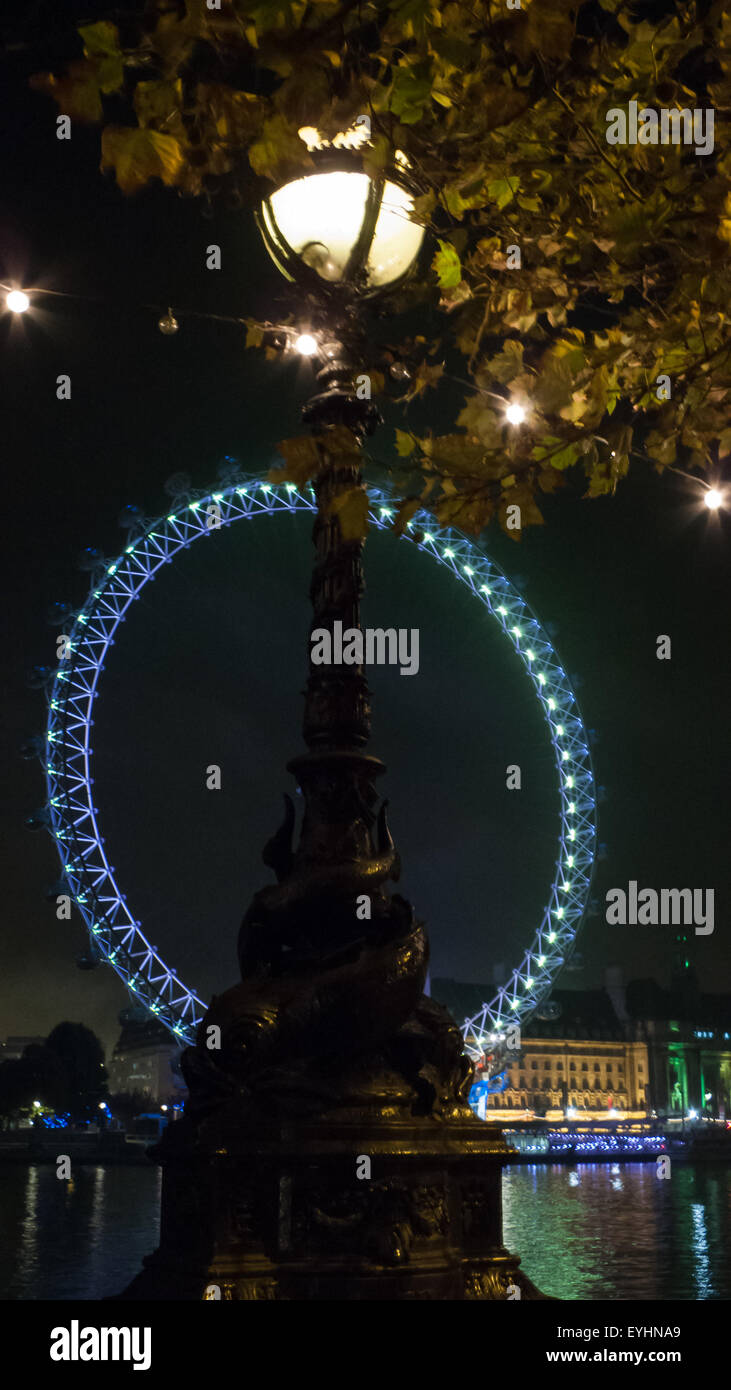 London, England. London Eye at night, with one of the iconic 'Dolphin' lamps. Stock Photo
