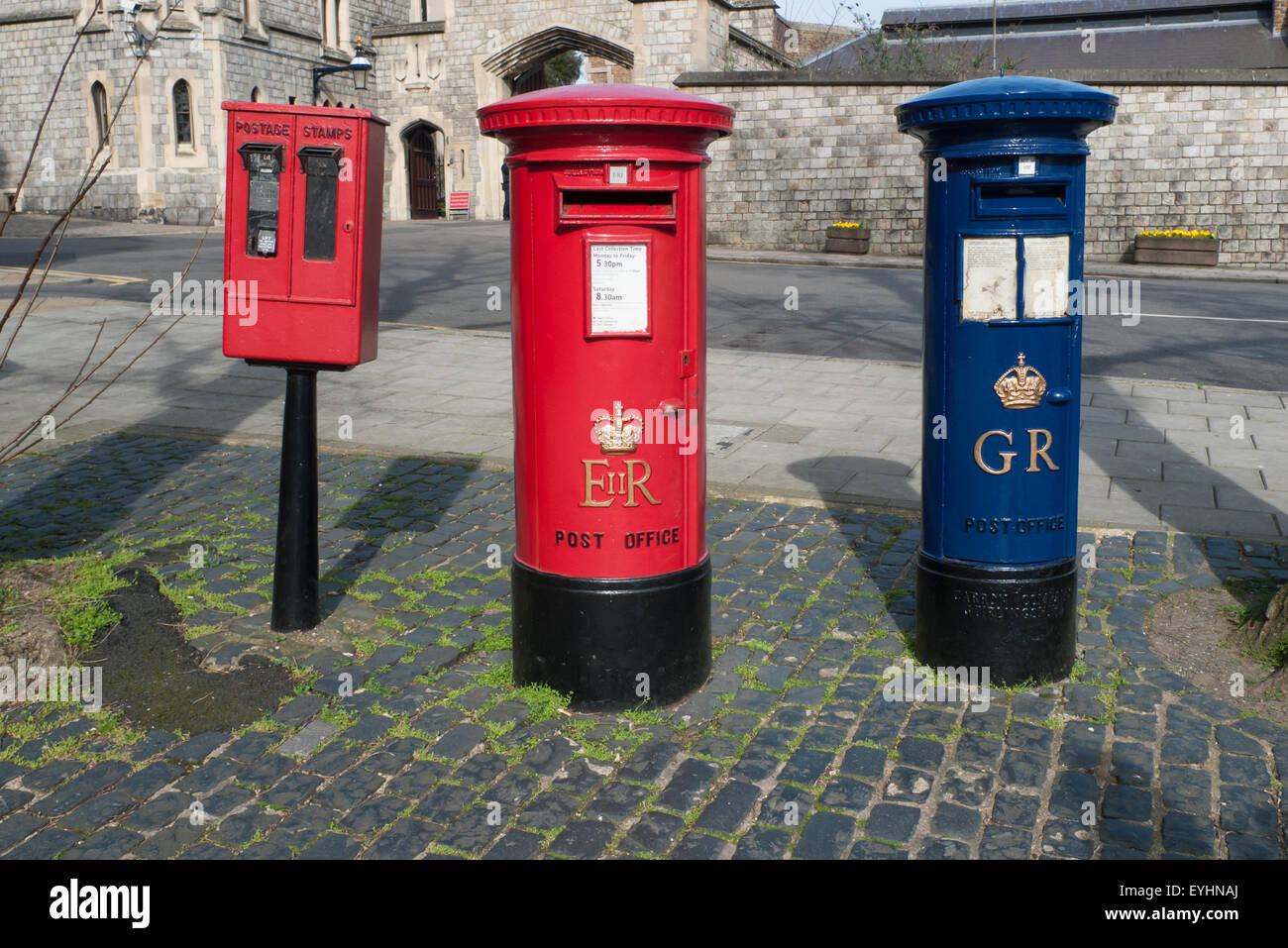 Windsor, England. Red postage stamp machine and post box marked EIIR, old blue airmail pillar box marked GR, Coronation Aerial post King George V. Stock Photo