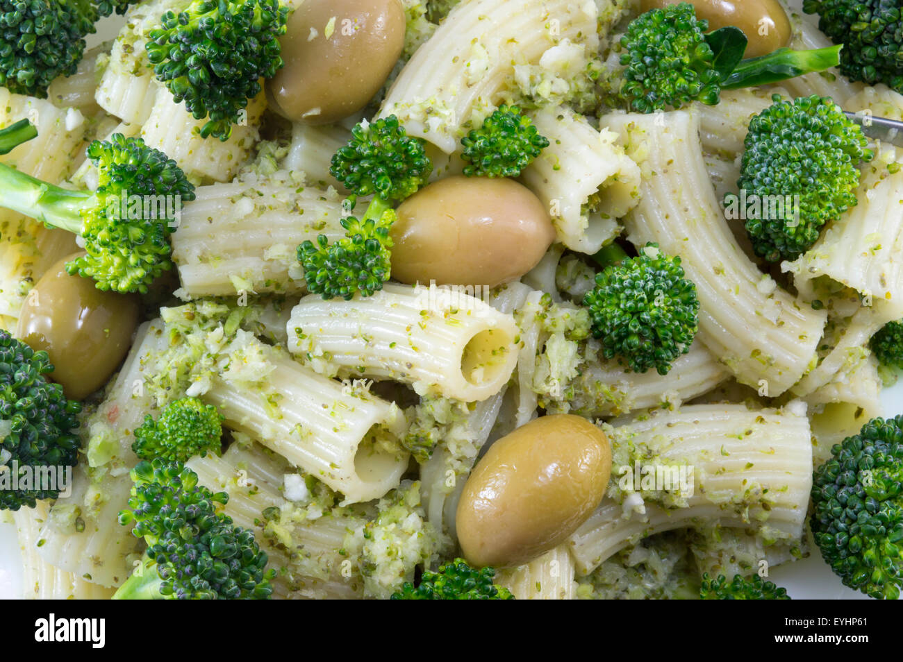 Pasta with broccoli and natural olives close up. Healthy pasta meal Stock Photo