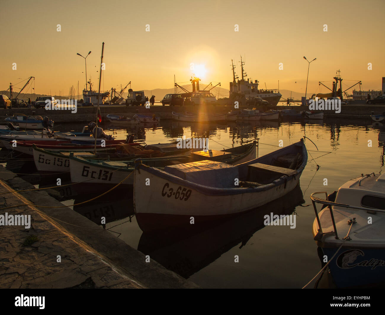 Fisherman boats on sunset Stock Photo - Alamy