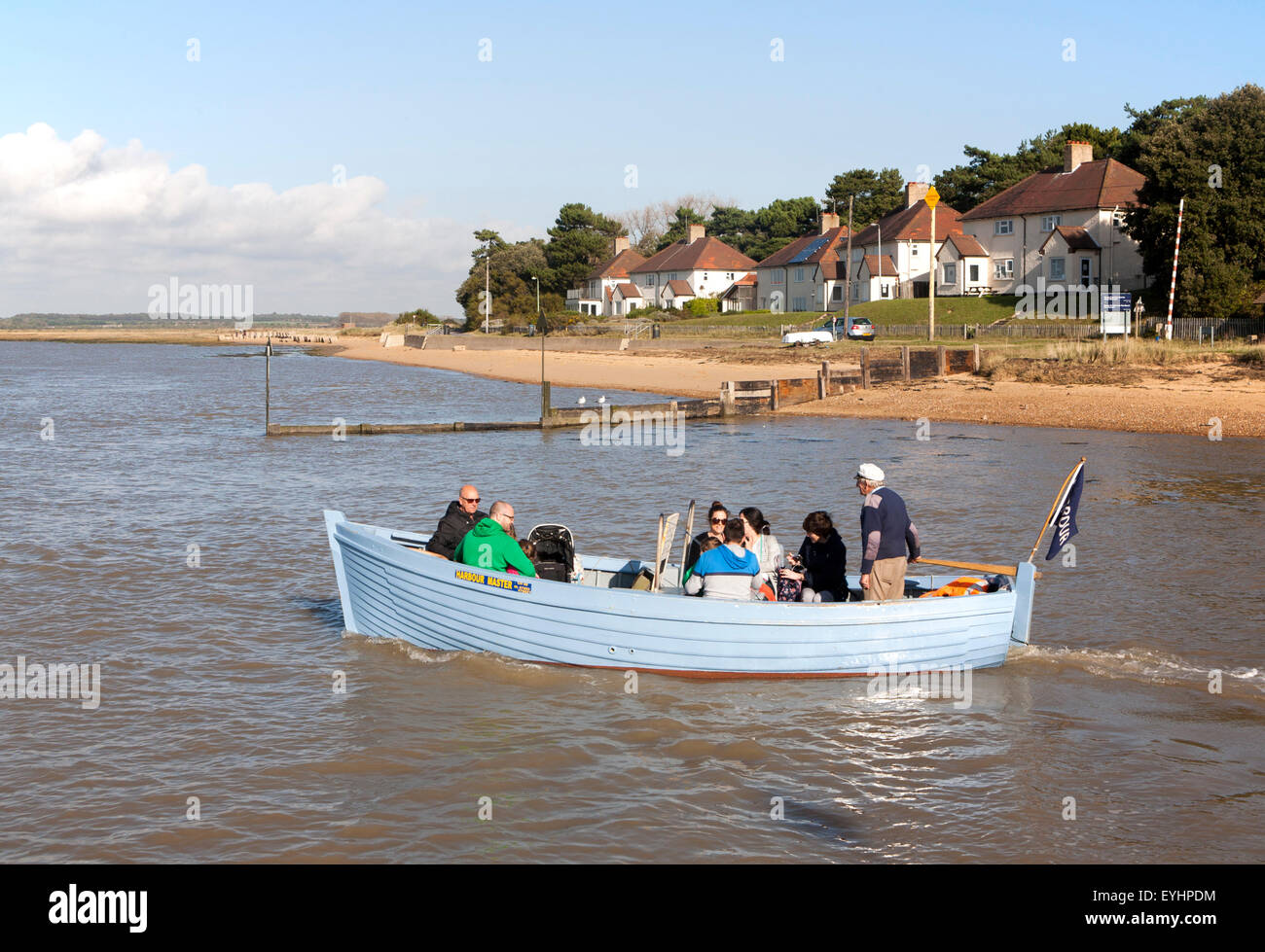 Small ferry boat crossing River Deben between Bawdsey Quay and