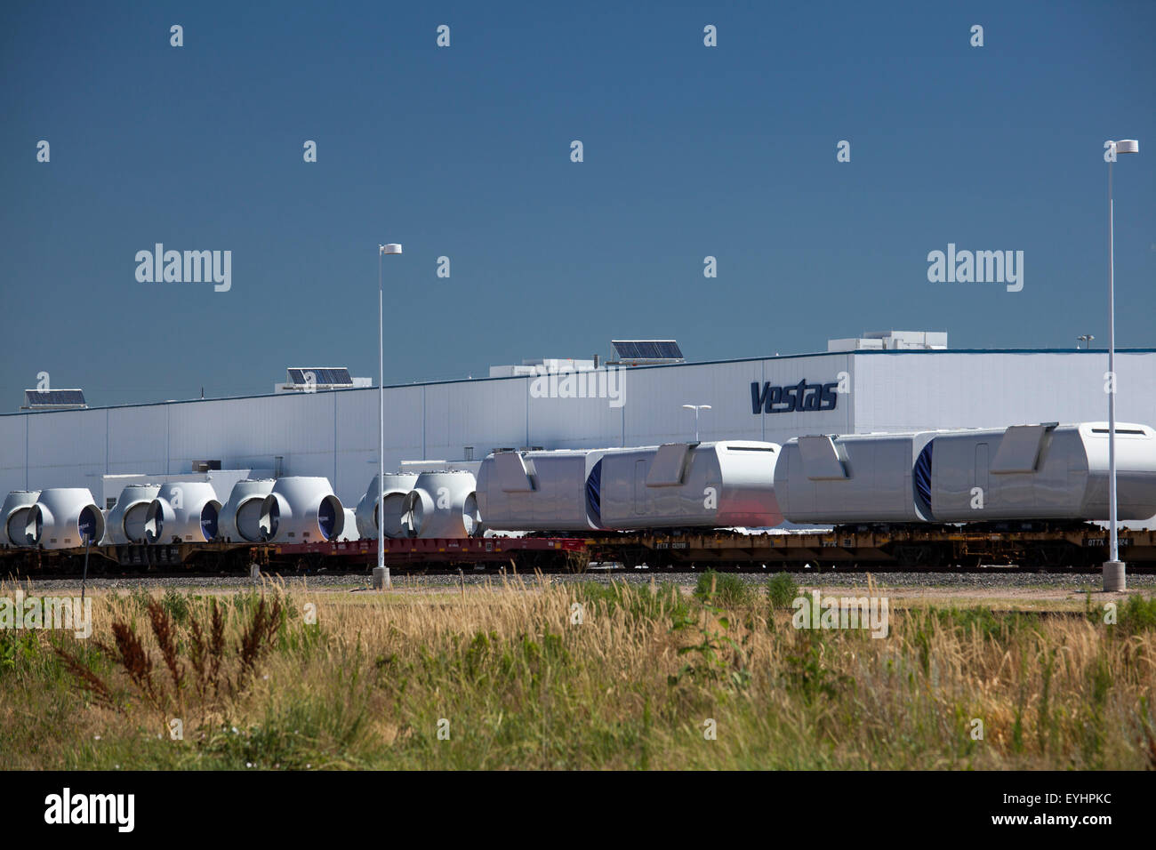 Brighton, Colorado - Nacelles and hubs for wind turbines on rail cars outside the Vestas Wind Systems factory. Stock Photo