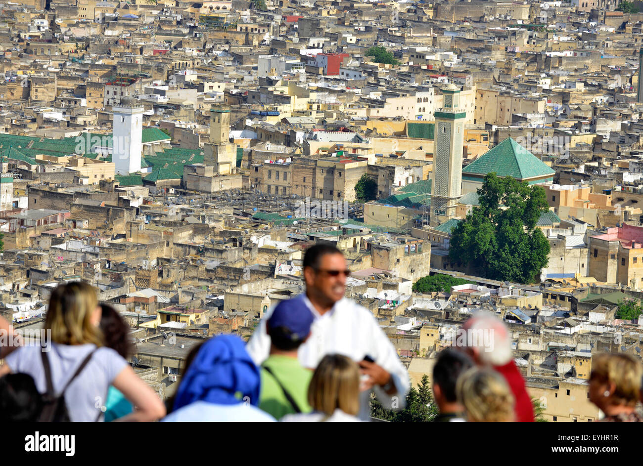 Fez, Fes, Morocco, North Africa. Tourists with Moroccan guide looking down on Fez, Morocco, North Africa. Stock Photo