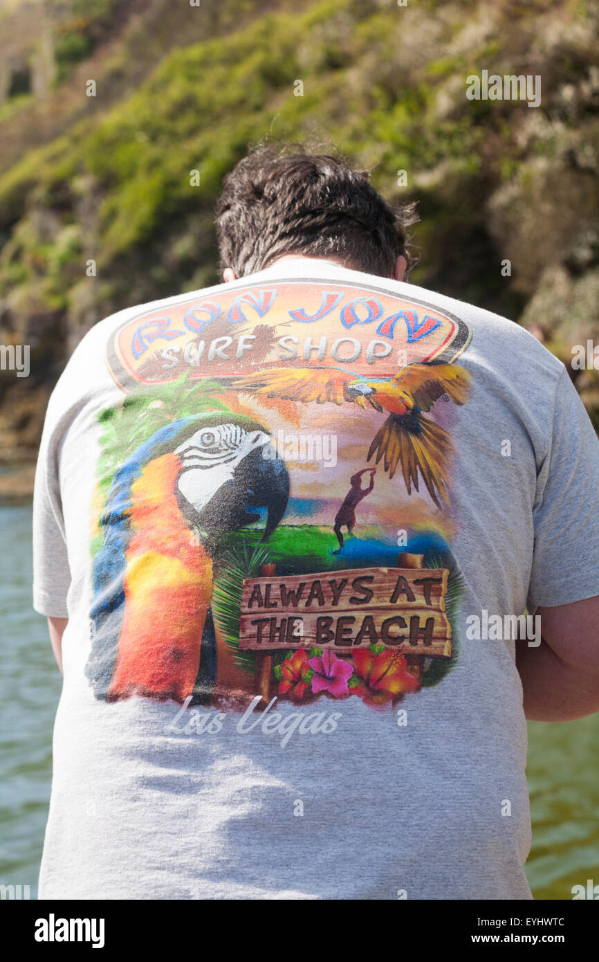 Man wearing Ron Jon Surf Shop Always at the Beach t-shirt at Porthclais, Pembrokeshire Coast National Park, Wales UK in May Stock Photo