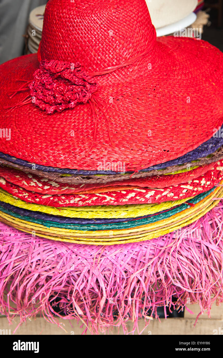Quatre Bornes, Mauritius. Red straw hat and others for sale at the market. Stock Photo