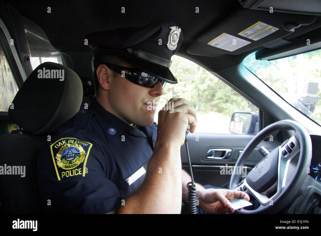 Police officer speaking on a police radio, Oak Bluffs, Massachusetts, USA Stock Photo