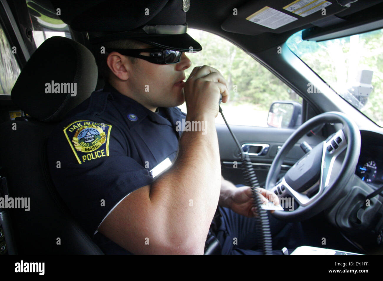 Police officer speaking on a police radio, Oak Bluffs, Massachusetts, USA Stock Photo