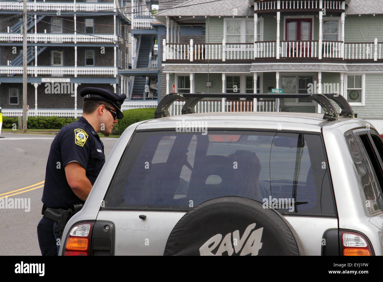 Police officer speaking to a car driver, Oak Bluffs, Martha's Vineyard, Massachusetts, USA Stock Photo