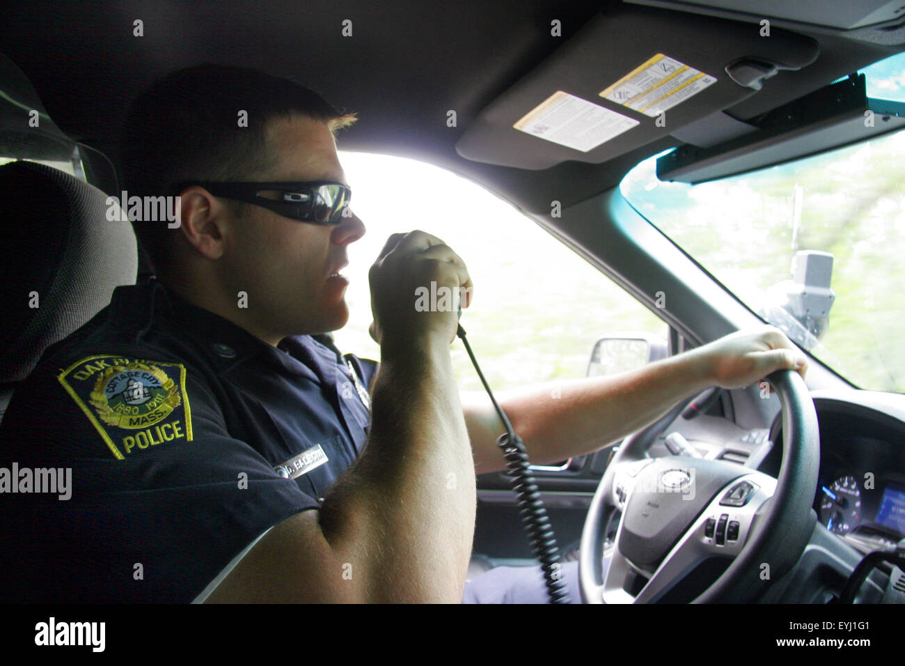 Police officer speaking into a police radio , Oak Bluffs, Martha's Vineyard, Massachusetts, USA Stock Photo
