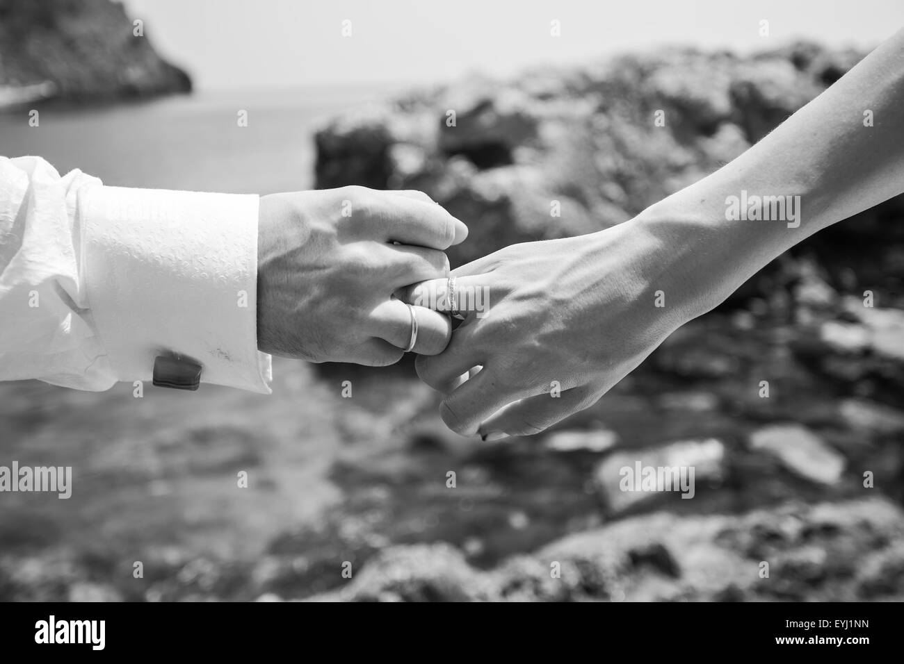Holding Hands with wedding rings Stock Photo Alamy
