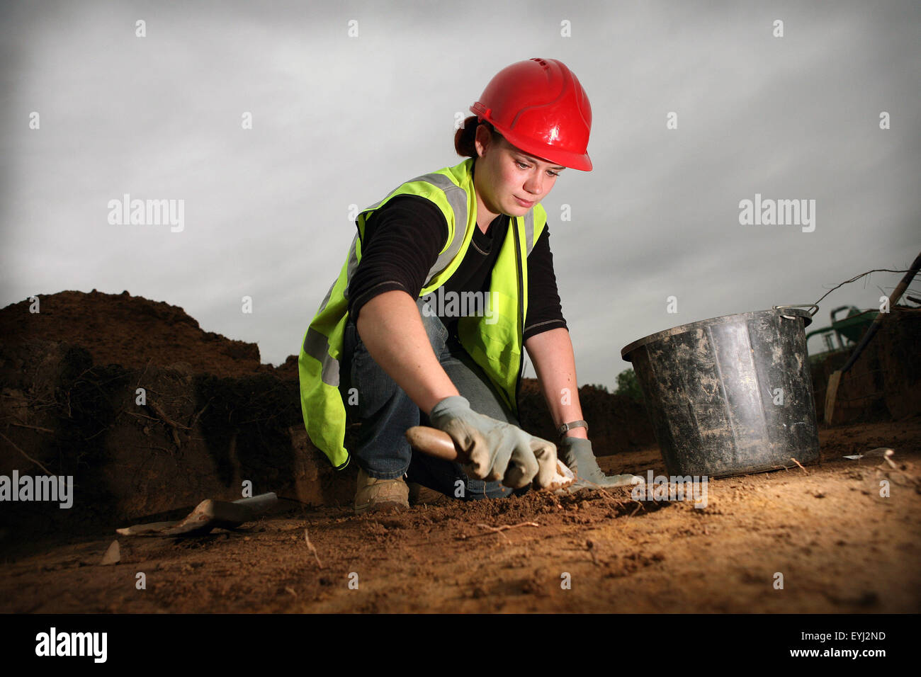 Archaelogical dig at City of Salford Stadium site. Archaelologist Jo Wright,31, excavates a linear feature. Stock Photo