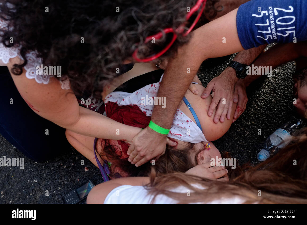 Young Israeli Shira Banki, 16, lies in the ground bleeding after being stabbed by an ultra Orthodox Jewish man at the annual Pride Parade in Jerusalem on 30 July 2015. Israel is widely seen as having liberal gay rights policies, despite the hostility shown towards homosexuals, particularly men, from the ultra-Orthodox Jewish community Credit:  Eddie Gerald/Alamy Live News Stock Photo