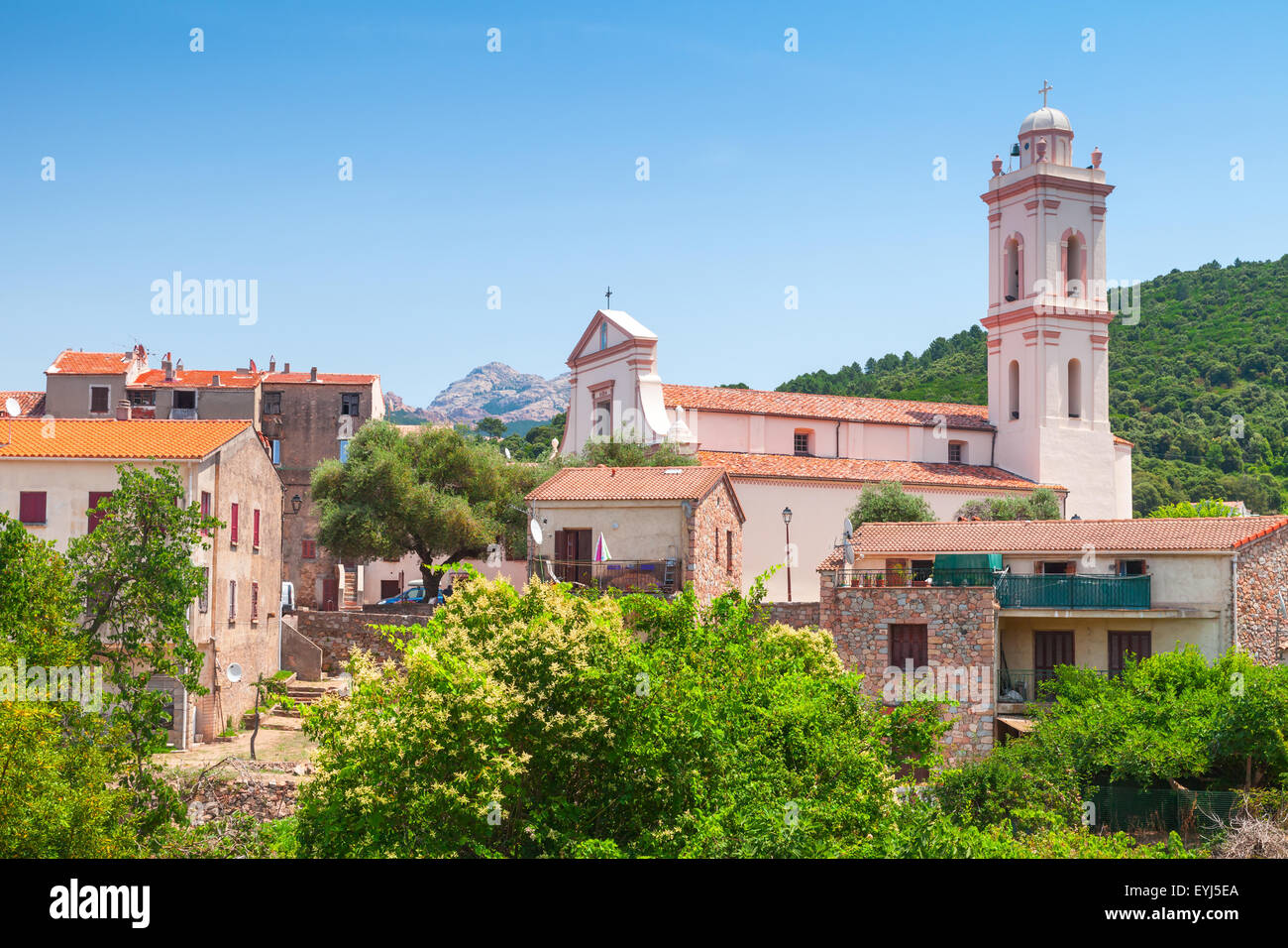 Small Corsican town landscape, old living houses with red tile roofs and bell tower. Piana, South Corsica, France Stock Photo