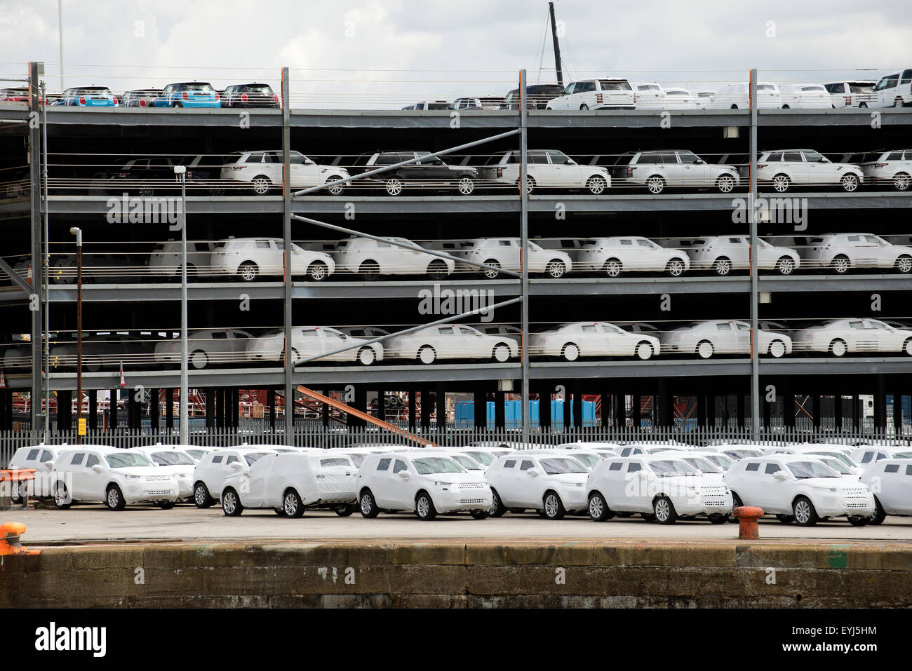 Luxury cars wrapped for protection for export from the UK on the docks at Southampton Stock Photo