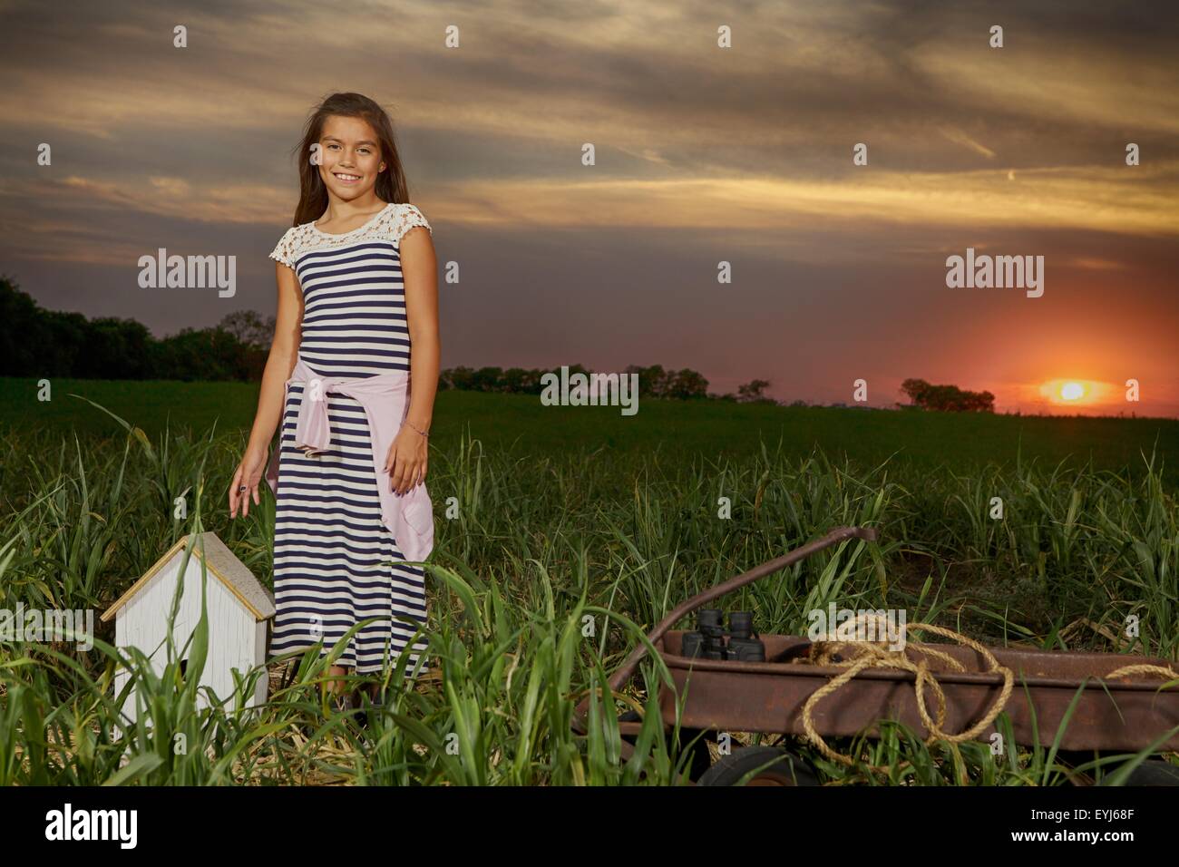 Girl in field at sunset. Science and discovery Stock Photo - Alamy