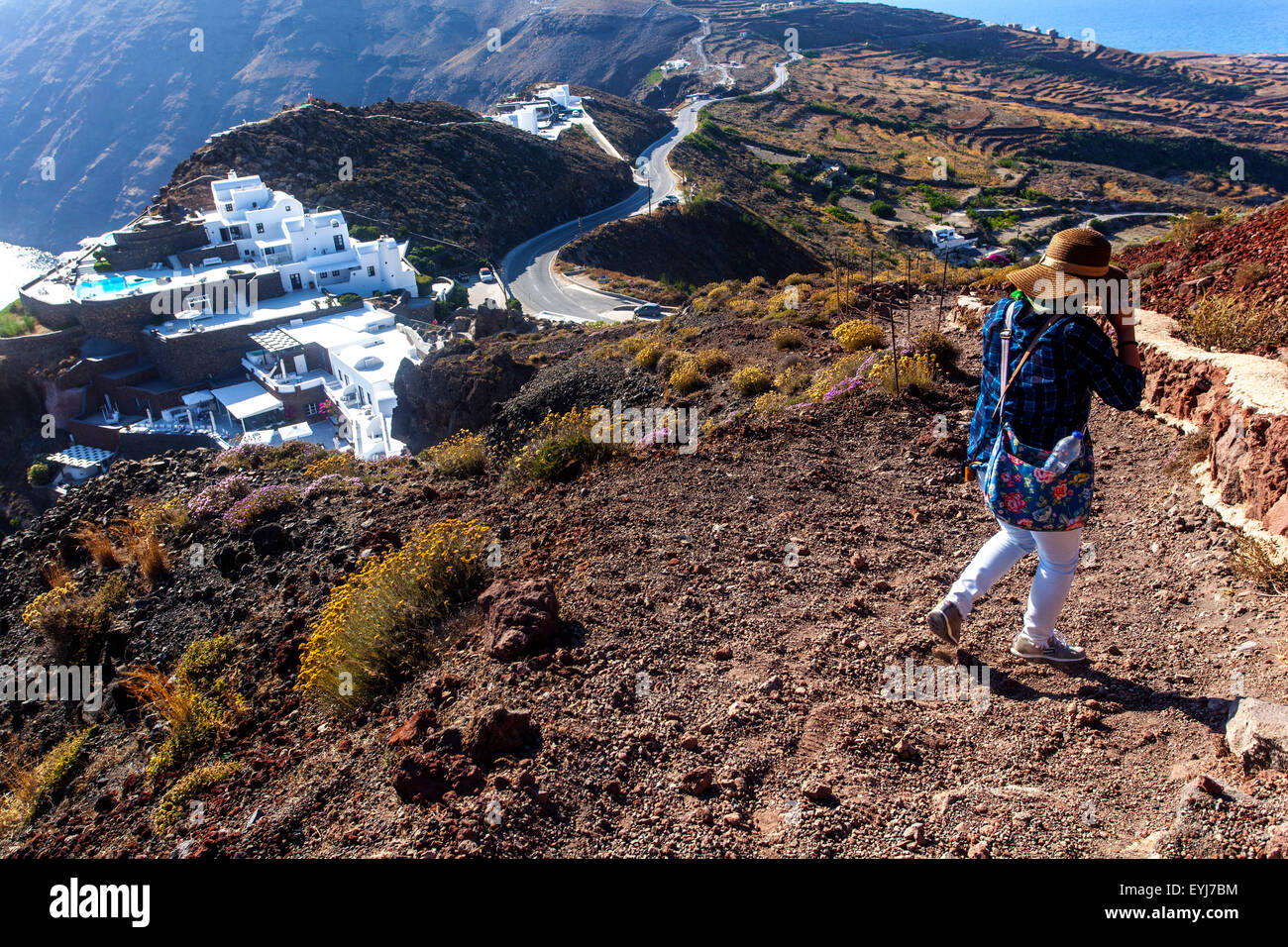 The path from Imerovigli to Oia, Santorini tourist woman hike, Way downhill, Greek Islands, Cyclades, Greece Stock Photo
