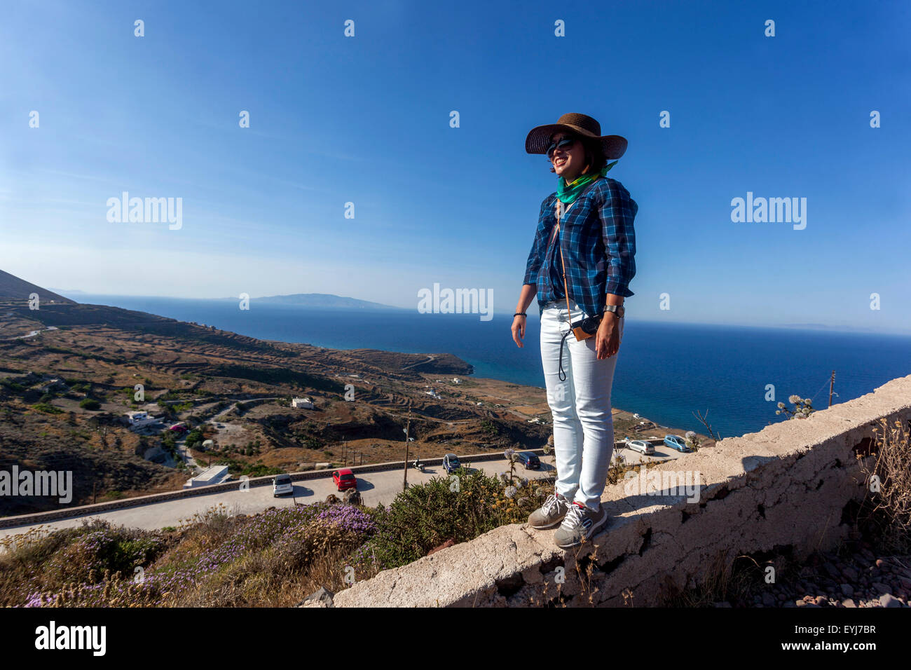 Woman on the path from Imerovigli to Oia, Santorini tourist Greek Islands, Cyclades Greece Stock Photo