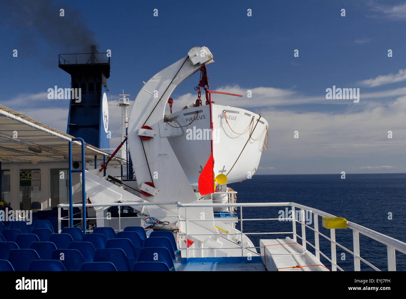 Seats on a Greek ferry boat, Aqua Maria, a davit hodling a rescue boat