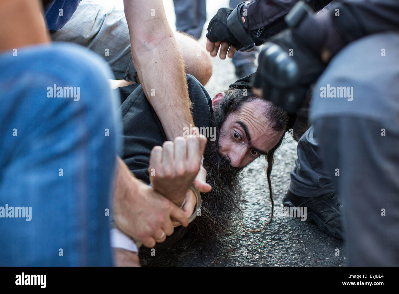 Jerusalem. 30th July, 2015. A Jewish ultra-Orthodox assailant is detained by Israeli police after he stabbed people during the annual gay pride parade in Jerusalem, . Six people were stabbed at Jerusalem's annual gay pride parade on Thursday, in one of the gravest attacks on the gay community in Israel, Israeli officials and eyewitnesses told Xinhua. A police spokesperson said the assailant was captured and identified as Yishai Schlissel, a Jewish ultra-Orthodox man who carried out a similar attack in 2005, injuring three people. Credit:  Xinhua/Alamy Live News Stock Photo