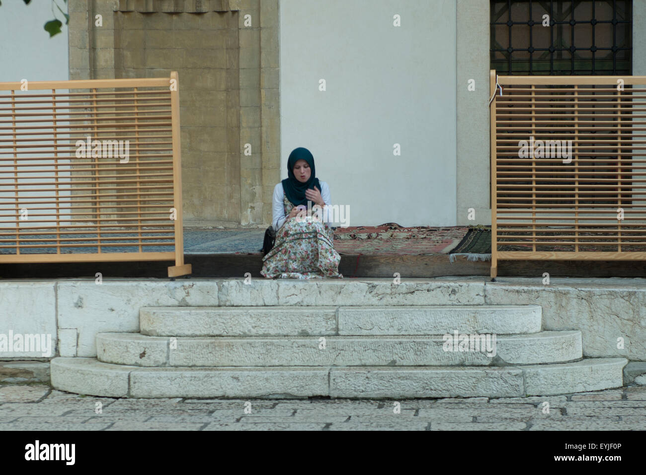 young girl in the courtyard of a mosque in Sarajevo Stock Photo