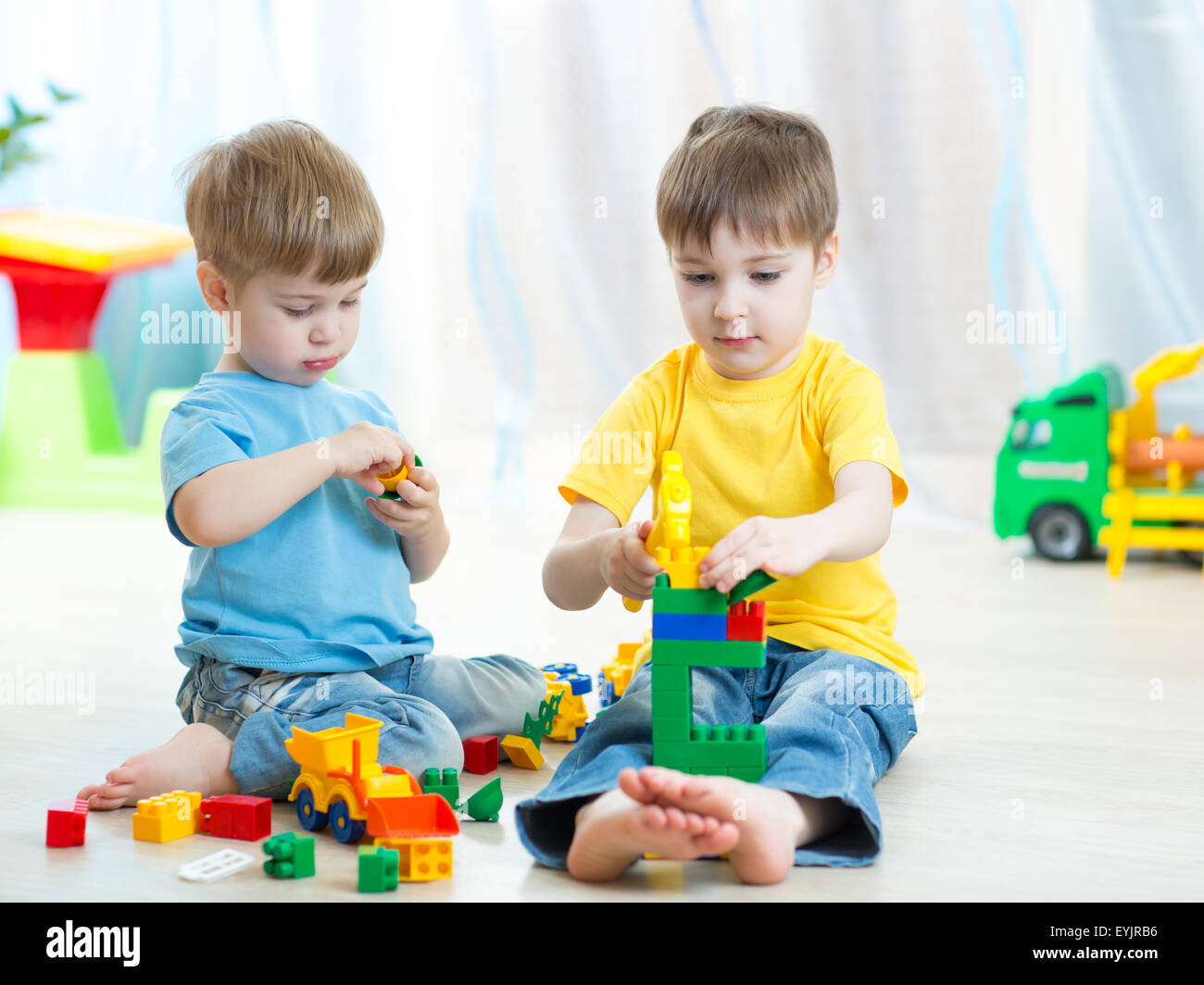 Little kids play with building bricks in preschool Stock Photo