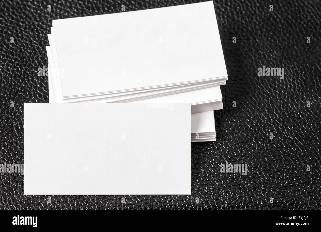 Blank business cards on black leather background. Mock up for Your text Stock Photo