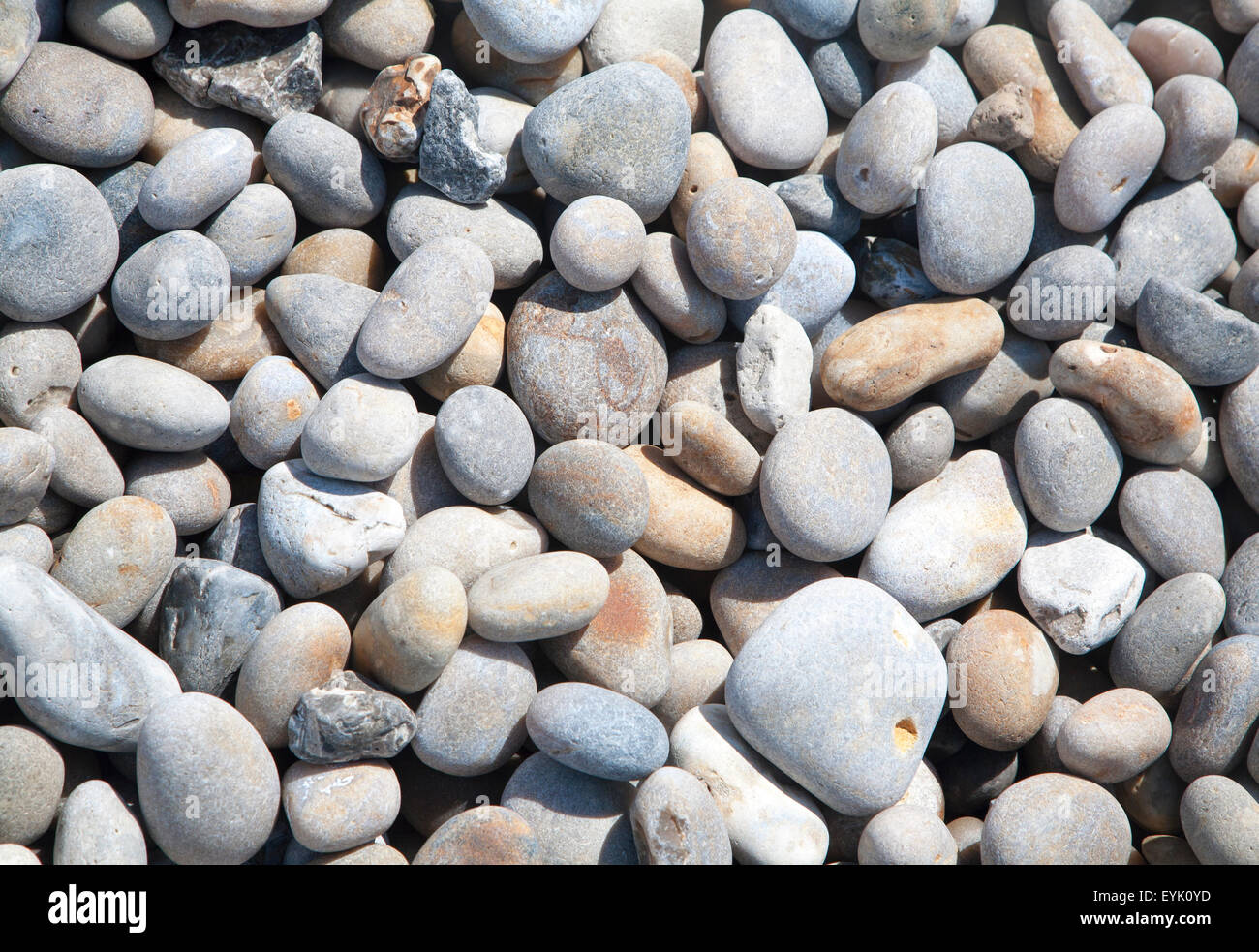 Close up of rounded beach pebbles looking down from above High