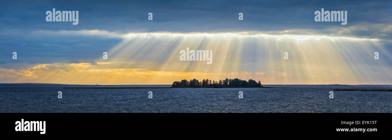 Panorama of lake sunset with sunrays coming through clouds. Lake Narach, Belarus Stock Photo