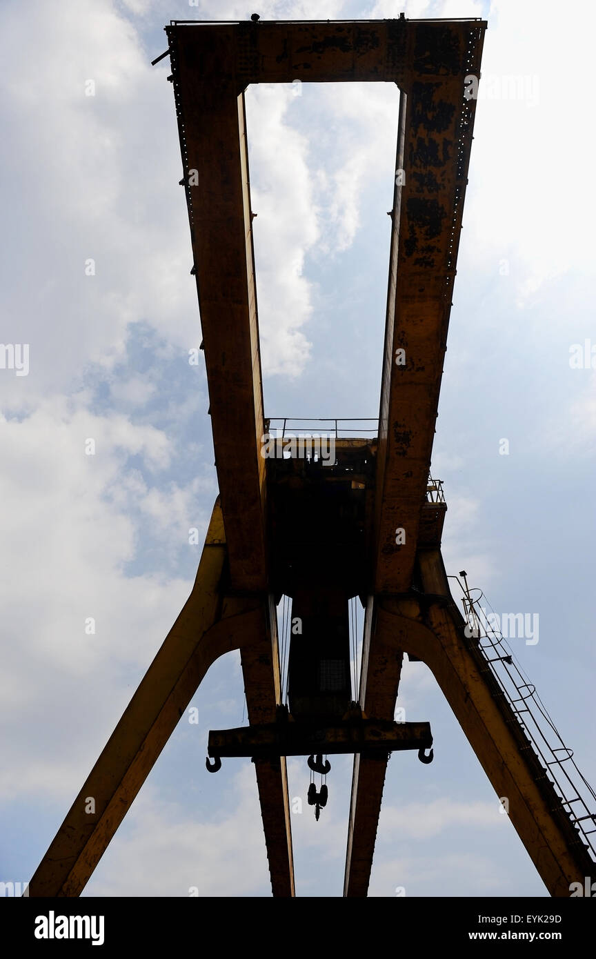 Industrial crane silhouetted against overcast sky Stock Photo