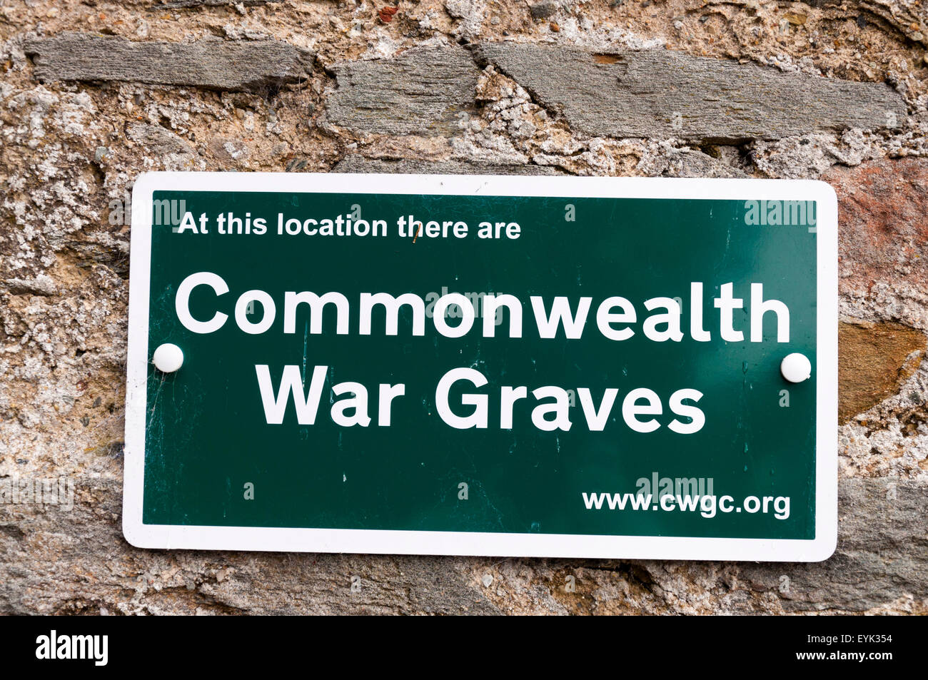 Sign signage At this location there are Commonwealth War Graves Stock Photo