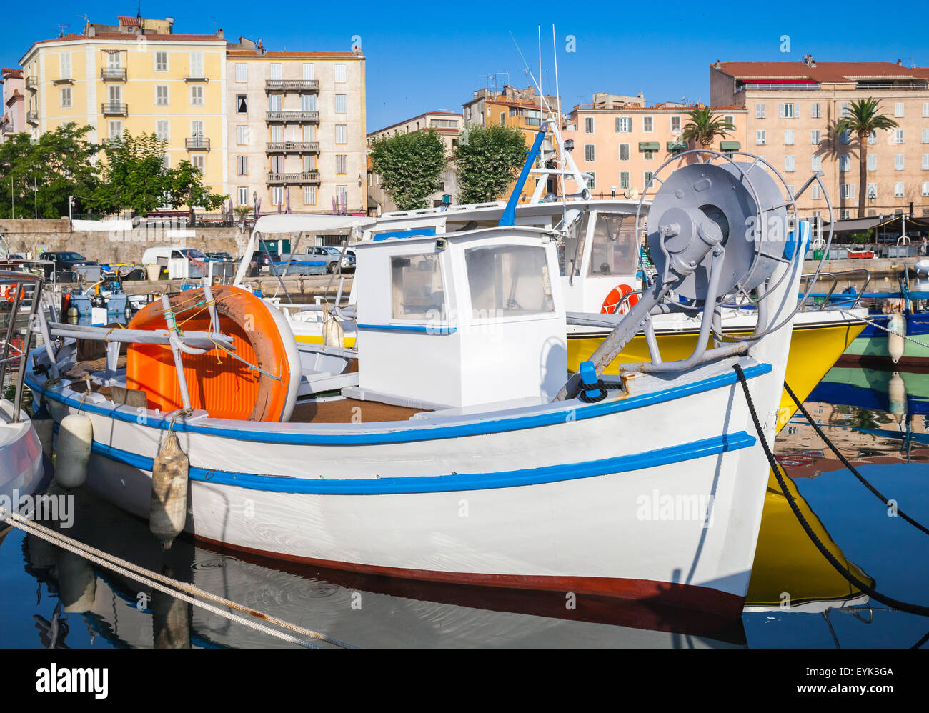 Small white wooden fishing boat moored in Ajaccio port, Corsica, France Stock Photo