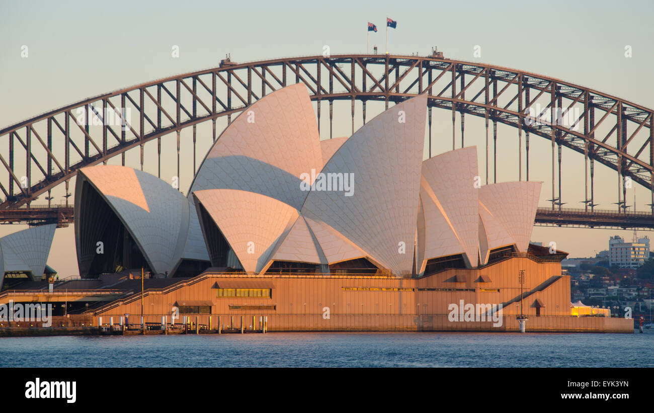 Early morning warm sun on the eastern side of the Sydney Opera House and the Sydney Harbour Bridge in Australia. Stock Photo